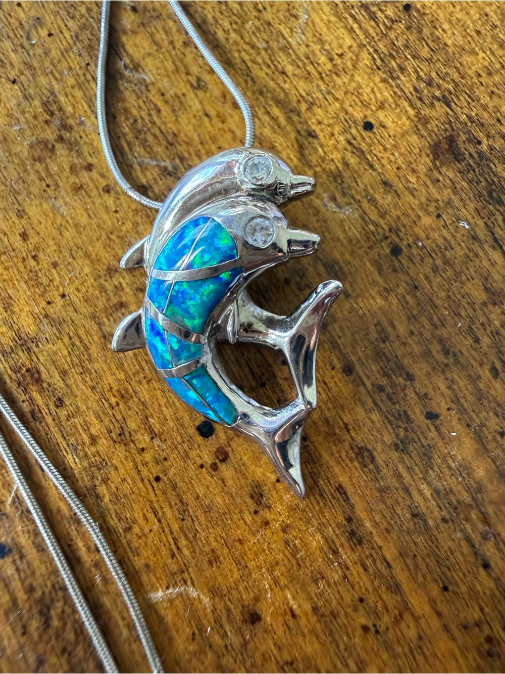 Blue Opal double dolphin pendant with 16” chain, cubic zirconia accents
